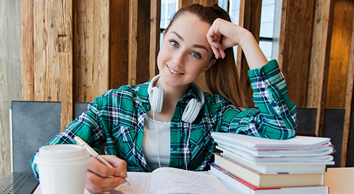 Teen Girl at Desk with Stack of Papers